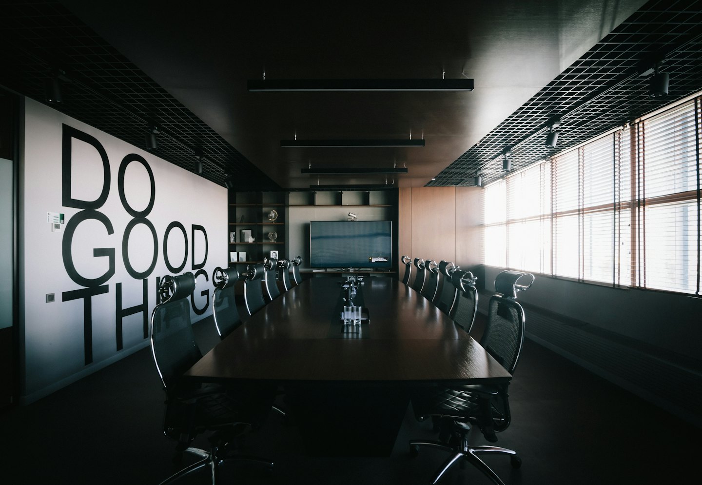 Modern conference room with 'DO GOOD THINGS' on the wall.